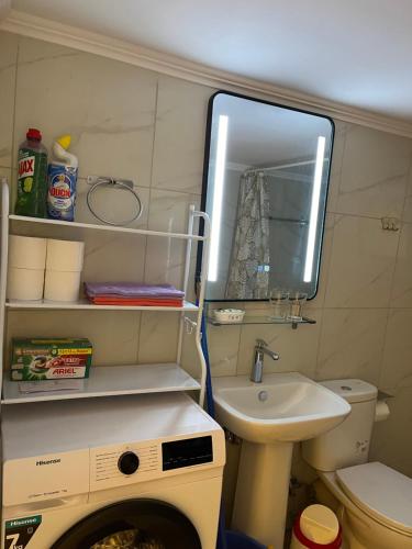 a small bathroom with a sink and a washing machine at Star Hostel in Piraeus
