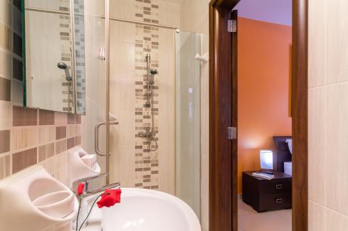 a bathroom with a white sink and a shower at Maisonnette & Pool Ta'Cenc Sannat Gozo - Happy Rentals in Sannat