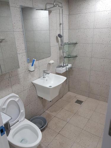 a bathroom with a toilet and a sink at Gilson Guesthouse in Sokcho