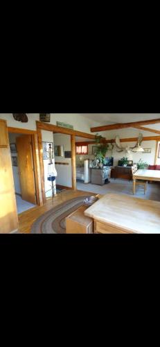 a large living room with a table and a couch at Raspberry Cottage in Homer