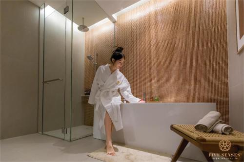 a woman in a bath tub in a bathroom at ViiA Residences Kuala Lumpur, Five Senses in Kuala Lumpur