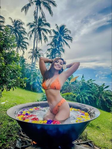 a woman is sitting in a bird bath at Bintana sa Paraiso Binunsaran in Mambajao