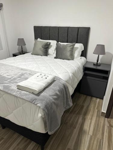 a bedroom with a large bed with two night stands at home 333 habitacion 337 in Escazu