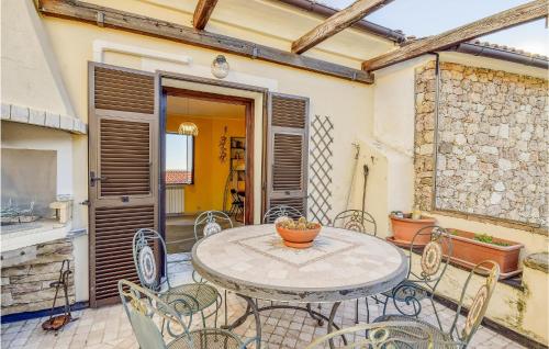 a patio with a table and chairs on a patio at 2 Bedroom Awesome Home In Vado Ligure in Vado Ligure
