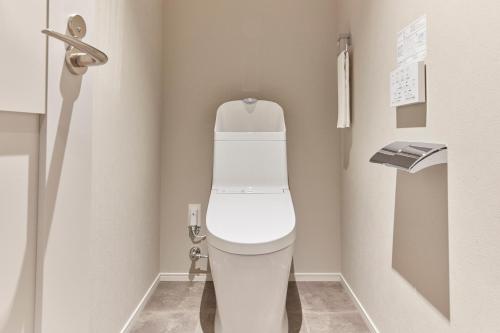 a bathroom with a white toilet in a stall at MONday Apart Premium Asakusa in Tokyo