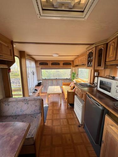 a kitchen and living room of an rv at Wathne Camping in Bjørheimsbygda