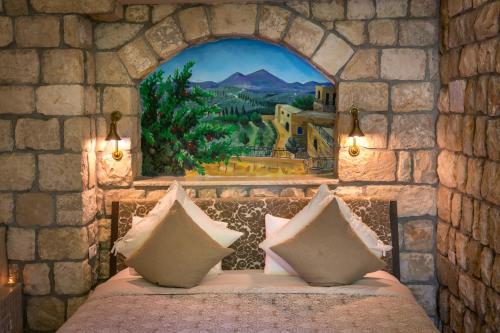 ein Schlafzimmer mit einem Bett in einer Steinmauer in der Unterkunft Beit Ha'Omanim in Safed