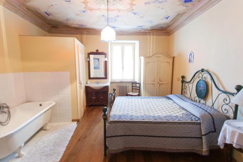 a bedroom with a bed and a tub and a sink at Montelupone Bed & Breakfast in Montelupone