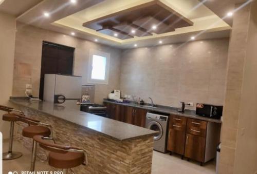 a large kitchen with a stove and a counter top at Hacienda bay in El Alamein