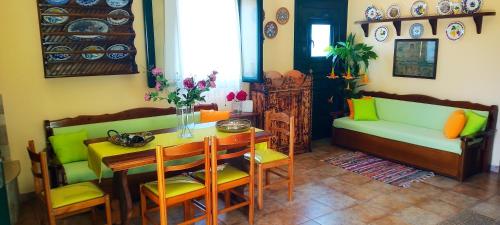 a living room with a table and a couch at Dora's House in Ístrios