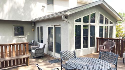 a patio with chairs and a table on a deck at Casa Grande Luxur in Overland Park