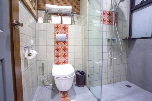 a bathroom with a toilet and a shower at Chankam Boutique Hotel in Chiang Mai