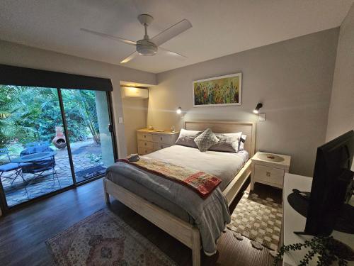 a bedroom with a bed and a sliding glass door at The Garden House BnB in Barellan Point