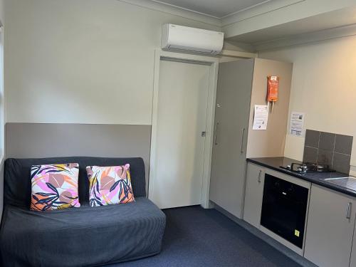 a living room with a couch in a kitchen at Camp Elim in Forster