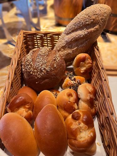 a basket full of different types of donuts and bread at Courtyard by Marriott Kunshan in Kunshan