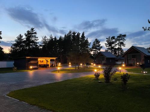 a night view of a house with lights in the yard at Peipsi Villad in Kuru