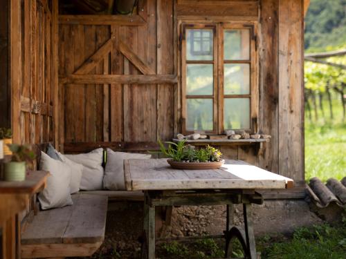 a wooden cabin with a table in front of a window at Arzenhof, Baron Di Pauli in Caldaro