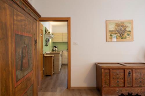 a hallway with a door leading to a kitchen at Arzenhof, Baron Di Pauli in Caldaro