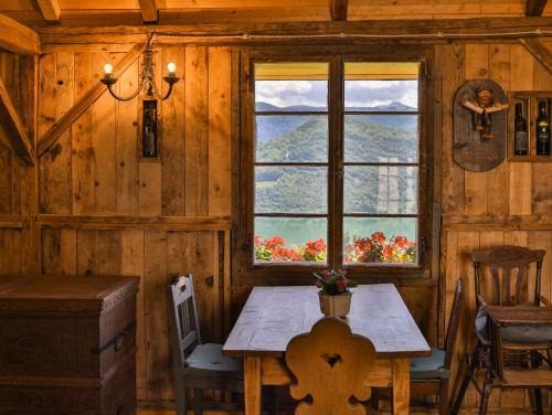 a wooden room with a table and a window at Arzenhof, Baron Di Pauli in Caldaro