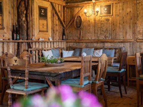 a wooden dining room with a wooden table and chairs at Arzenhof, Baron Di Pauli in Caldaro