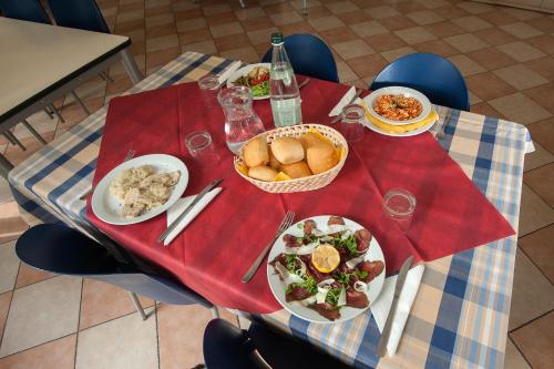 a table with plates of food on top at Ostello Città di Rovereto in Rovereto