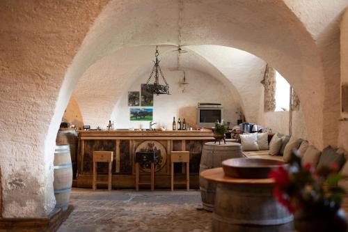 a room with a kitchen and a bar in a building at Arzenhof, Baron Di Pauli in Caldaro