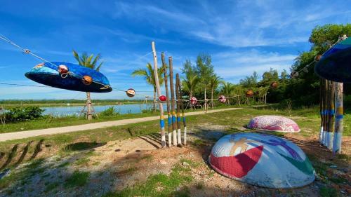 a group of objects in a field near a body of water at Lee House Villa Tam Thanh in Tam Ky