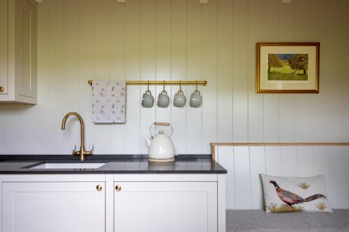 a kitchen with a sink and a counter top at Fallow Shepherds Hut Chatsworth Estate in Baslow
