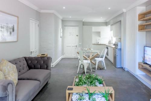a living room with a couch and a table at Sandton Cozy Apartment in Johannesburg