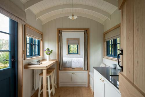 a small kitchen with a sink and a mirror at Stag Shepherds HutChatsworth Estate in Baslow