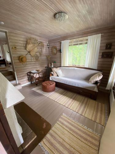 a large bedroom with a bed and a window at Rantamökki Cottage Vihti near Nuuksio in Huhmari