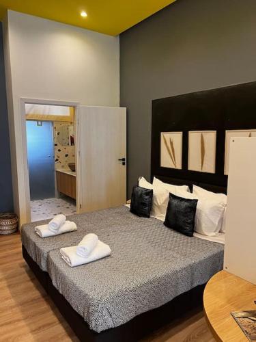 a bedroom with a large bed with two pillows on it at Modern apartment Downtown in Rethymno Town