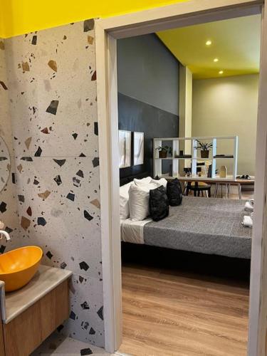 a bedroom with a large bed with a rock wall at Modern apartment Downtown in Rethymno Town