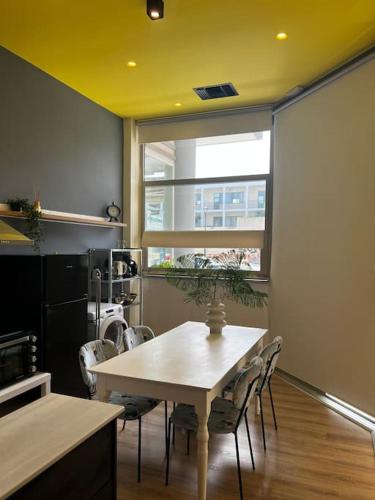 a dining room with a table and chairs and a window at Modern apartment Downtown in Rethymno Town