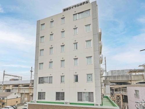 a tall white building in a city at Kumagaya Royal Hotel Suzuki in Kumagaya