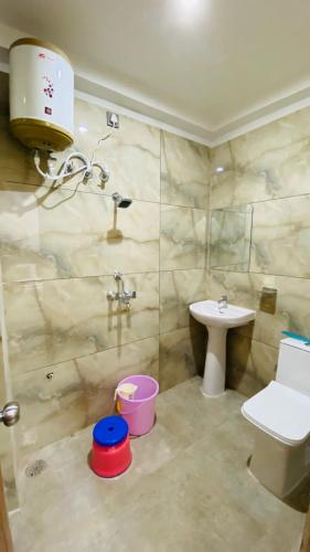 a bathroom with a toilet and a sink at Pine hills resort and restaurant in Barkot