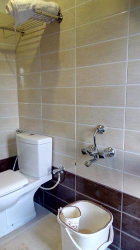 a bathroom with a toilet and a sink at Trial Based Hotel in Coonoor