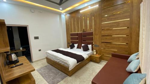 a bedroom with a bed and a couch at Pine hills resort and restaurant in Barkot