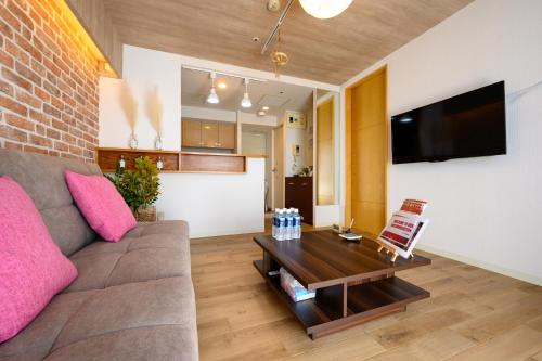 a living room with a couch and a coffee table at Nakajima Park Hotel AMS tower Nakajima 20F 2001 in Sapporo
