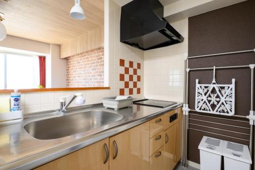 a kitchen with a sink and a counter top at Nakajima Park Hotel AMS tower Nakajima 20F 2001 in Sapporo