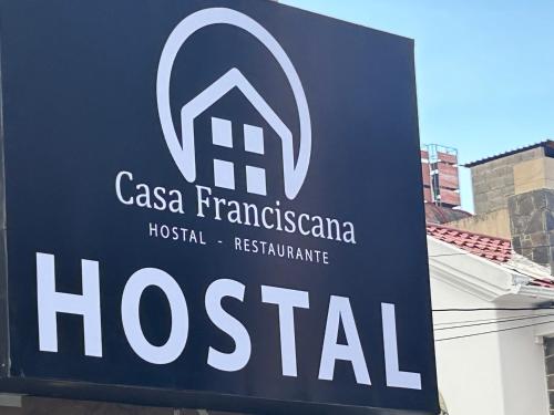 a sign for a hospital on the side of a building at Hostal CASA FRANCISCANA in Quito