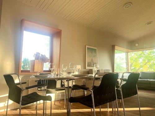 a dining room with a table and chairs and a window at Mysigt sommarhus med havsutsikt och bastu in Vaxholm