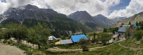 a village in a valley with mountains in the background at beheney Homestay in Kyelang