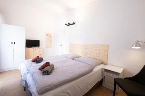 a bedroom with a bed with two teddy bears on it at Penzion Sport in Smokovce