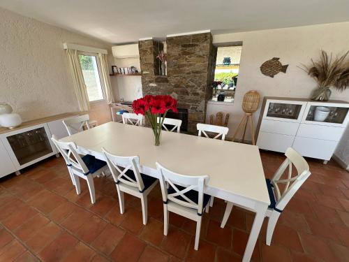 a dining room with a white table and chairs at Villa MahJong Piscine Vue Mer Clim 6 adultes et 2 enfants in Cavalaire-sur-Mer