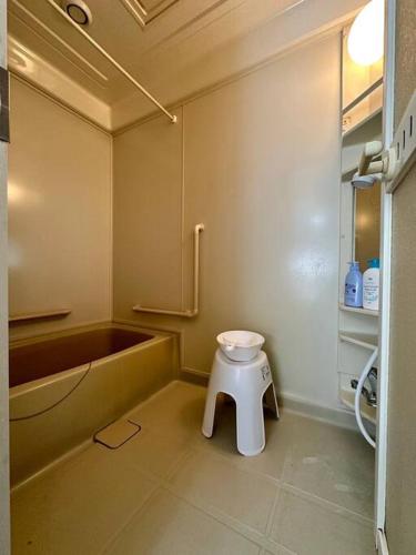 a bathroom with a toilet and a bath tub at Shakotan Detached House Stay in Shakotan