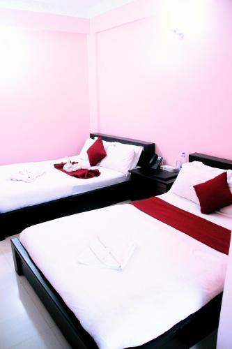two beds sitting next to each other in a room at Grand Selim Resort & Tour – GSRT in Sreemangal