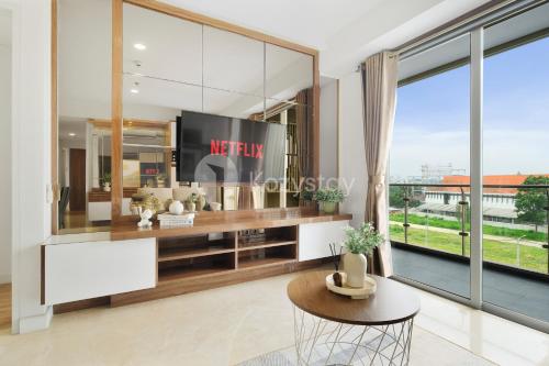 a living room with a large glass wall at Bhumi by Kozystay - Paskal in Bandung