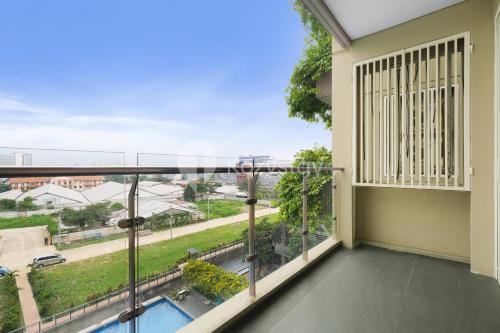 an apartment balcony with a view of a street at Bhumi by Kozystay - Paskal in Bandung