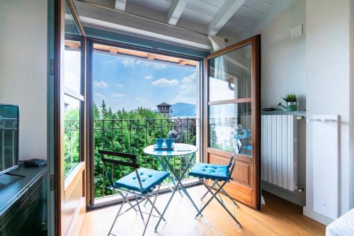 a room with a balcony with a table and chairs at Riflessi sul lago in Predore